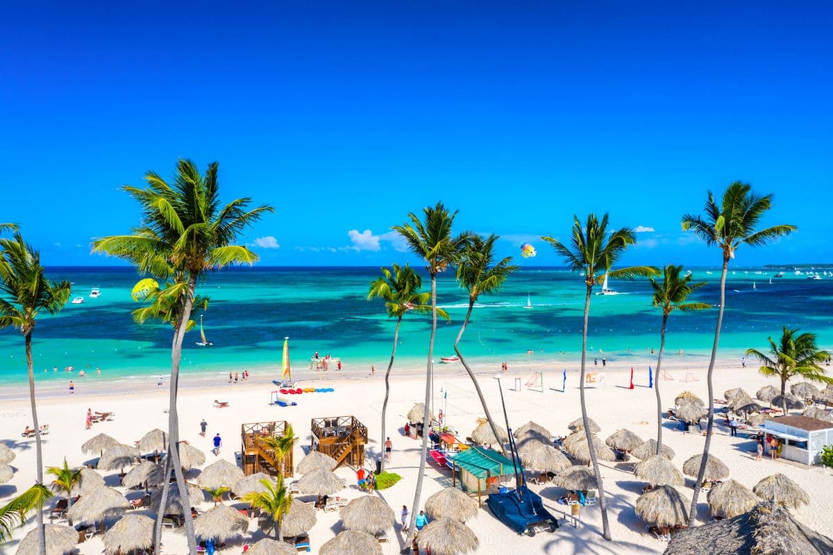 Aerial view of palm trees and straw umbrellas on Bavaro Beach in the Dominican Republic