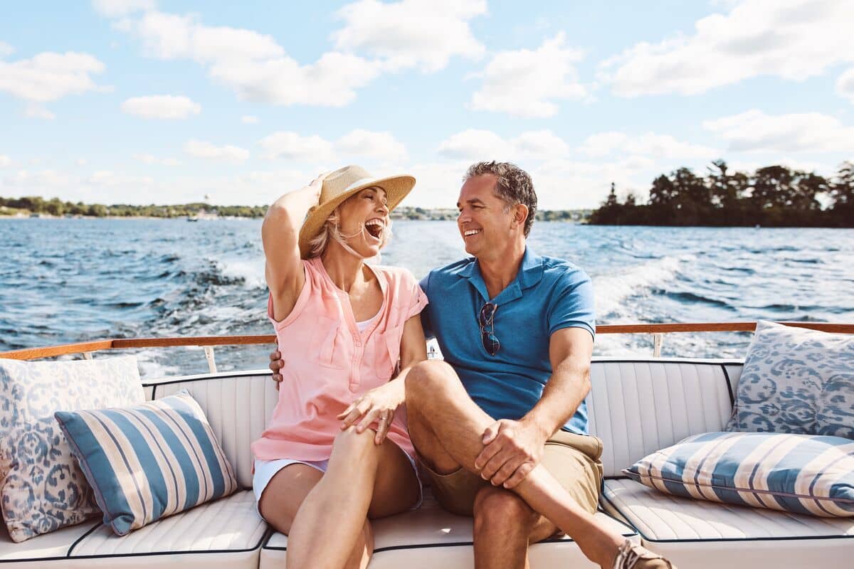 A happy middle-aged couple rides on a luxury boat