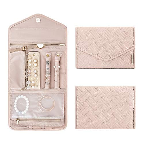 A foldable travel jewelry case in blush pink, shown open with rings, earrings, and bracelets inside, alongside the same case shown closed.