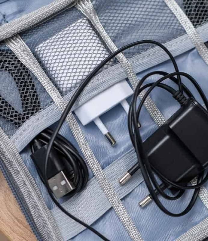 A cable organizer with neatly organized cords for a variety of devices.