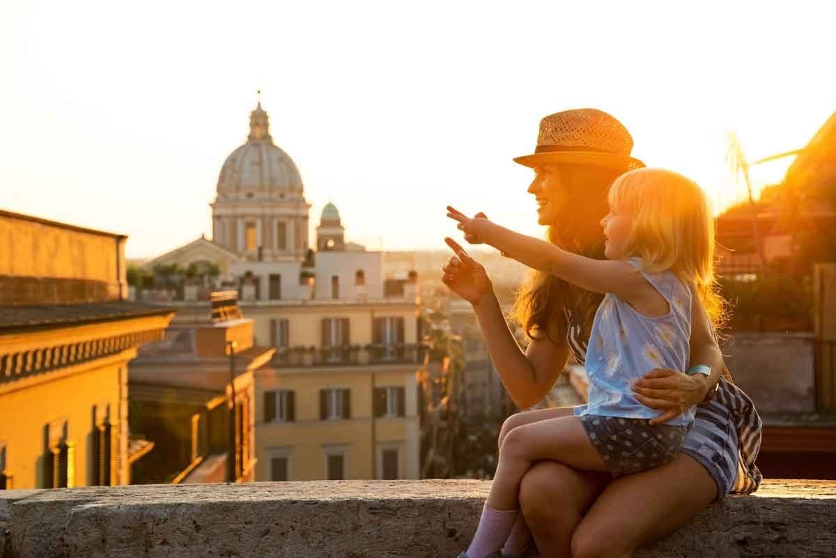 A mother and daughter overlooking the rooftops of Rome, Italy.