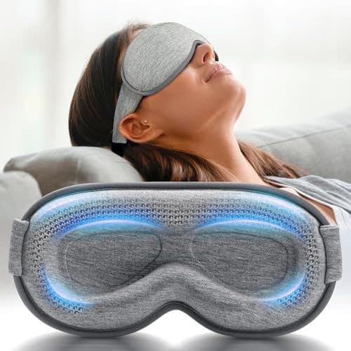 A woman relaxes on a couch wearing a FACEMOON weighted eye mask