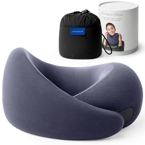 Ostrichpillow Go memory foam travel pillow in dark gray, with an ergonomic wraparound design for neck support, shown alongside its compact carrying case.