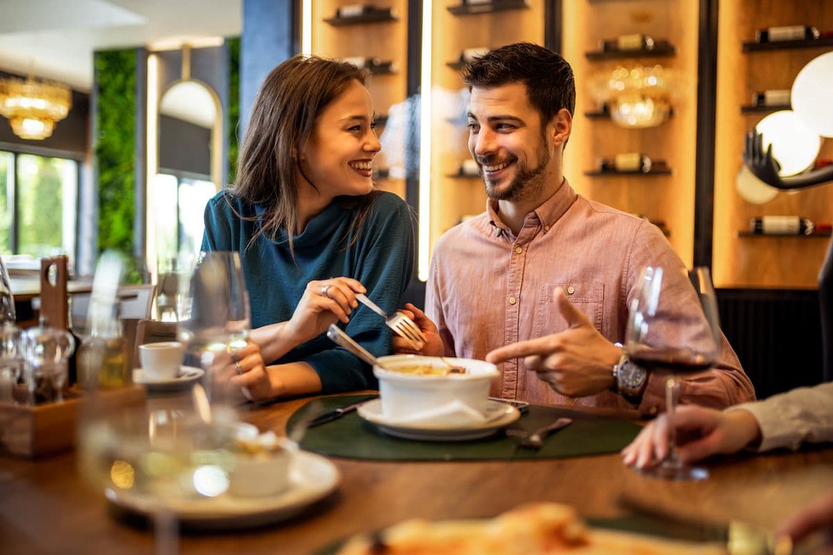 A happy couple eating at a restaurant.