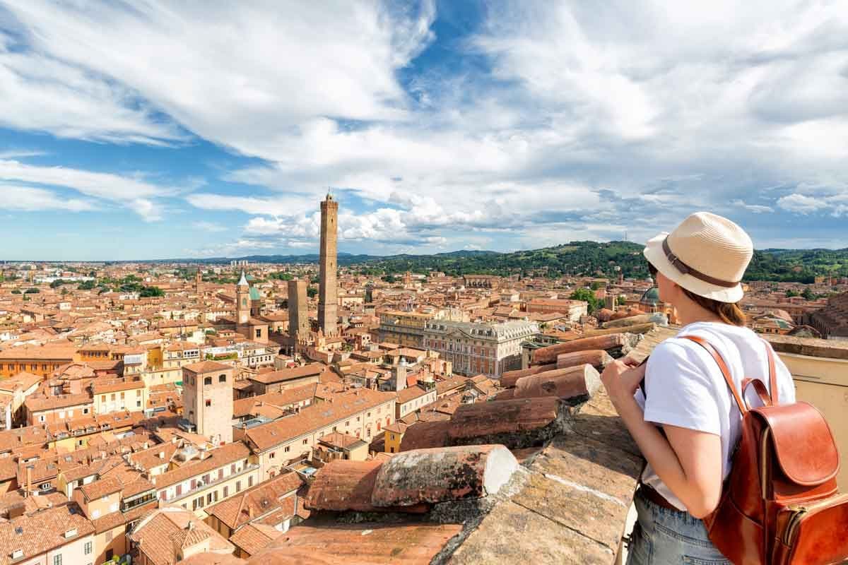 A female tourist looking out at the historic city of Bologna, Italy.