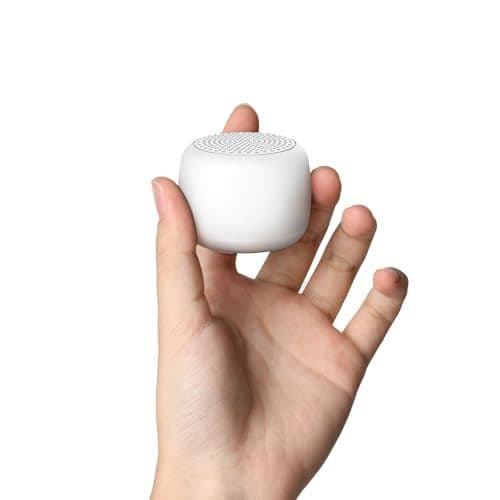 Hand holding a compact white noise machine